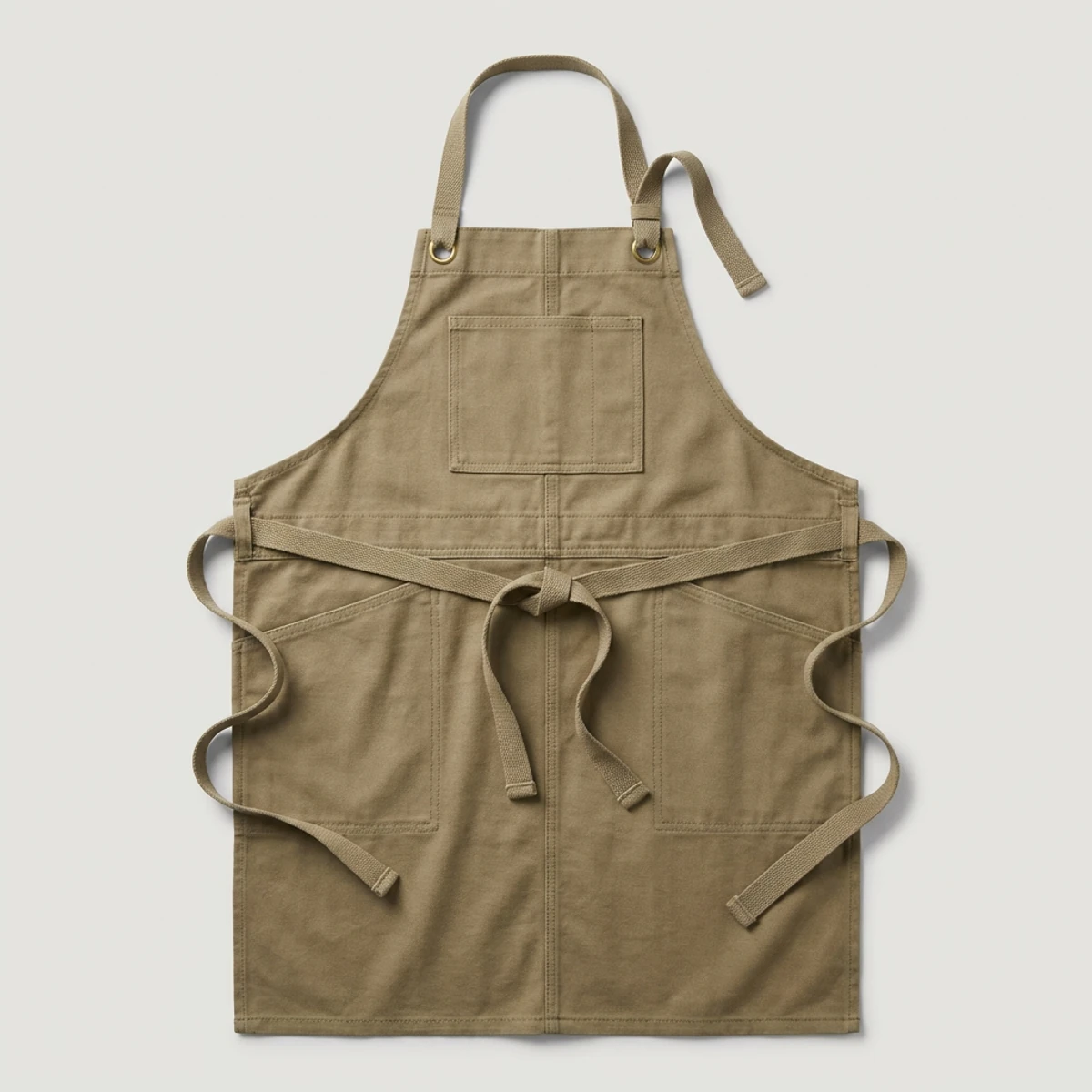 Khaki canvas bib apron with brass grommets and chest pocket