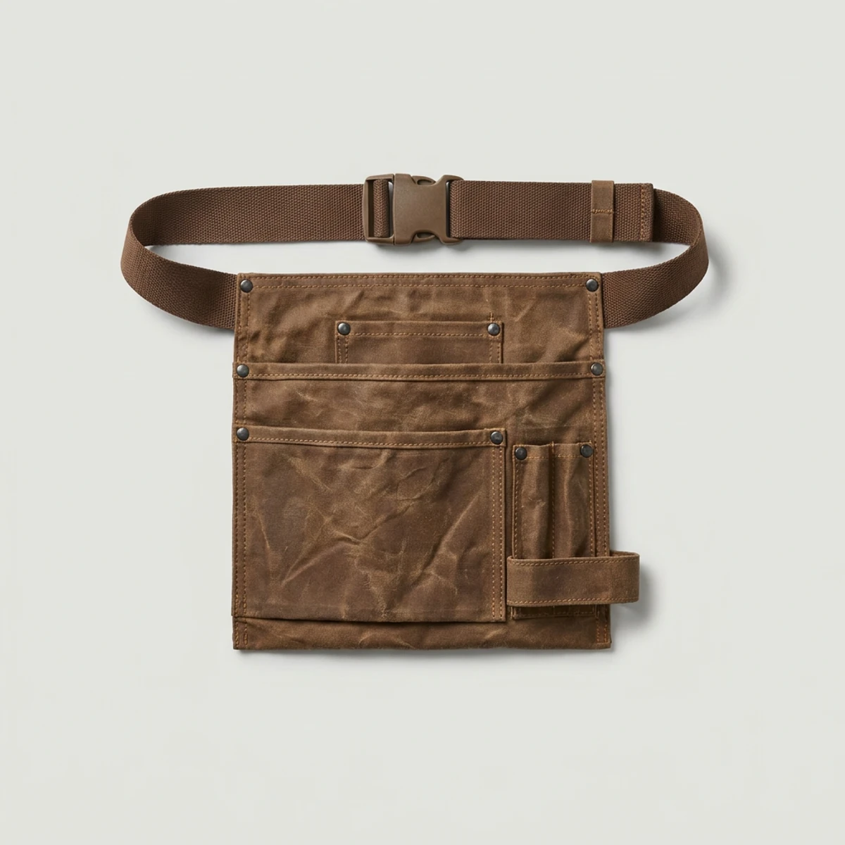 Brown waxed canvas tool apron with hammer loop and riveted pockets