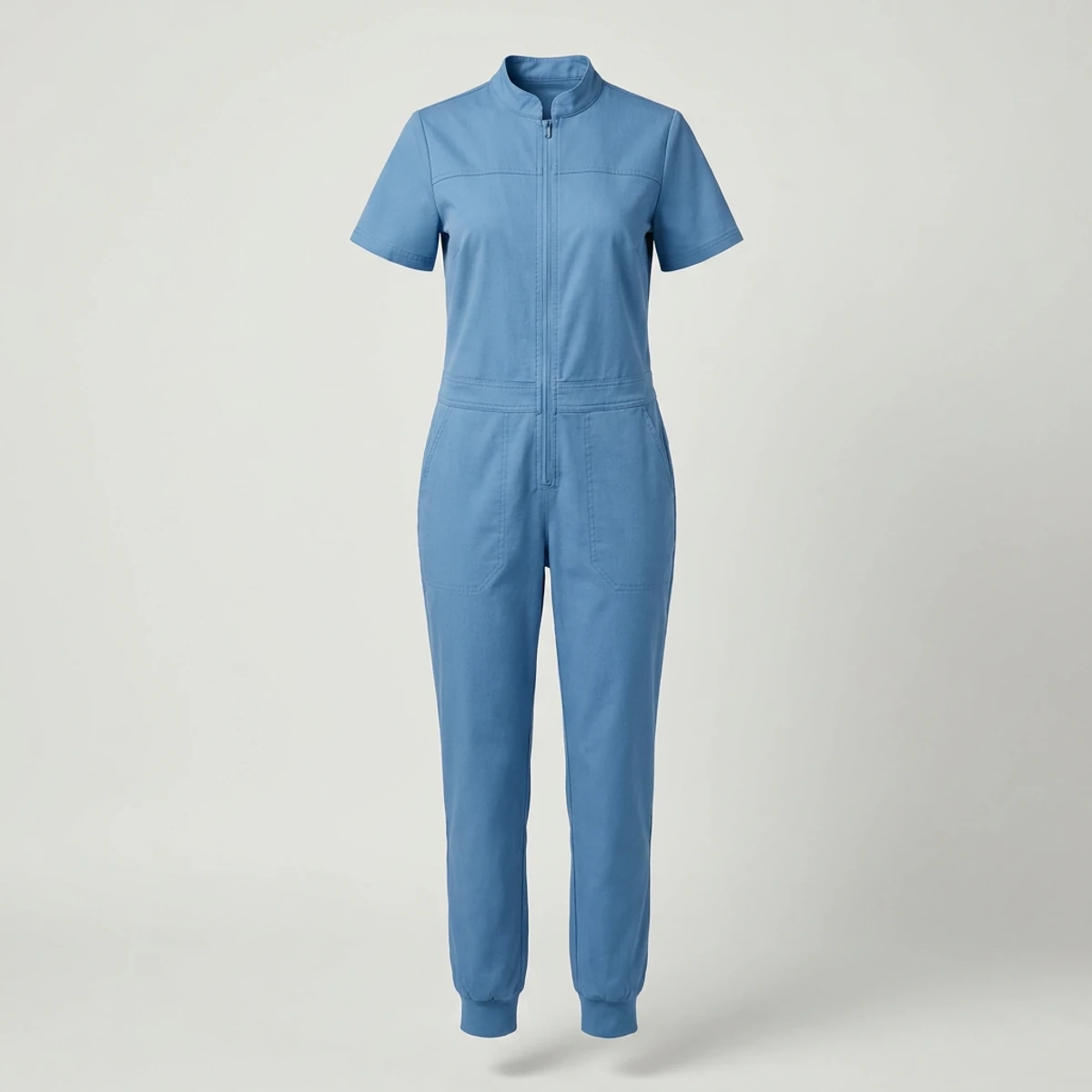 Ceil blue zip-front scrub jumpsuit with back yoke and jogger cuffs