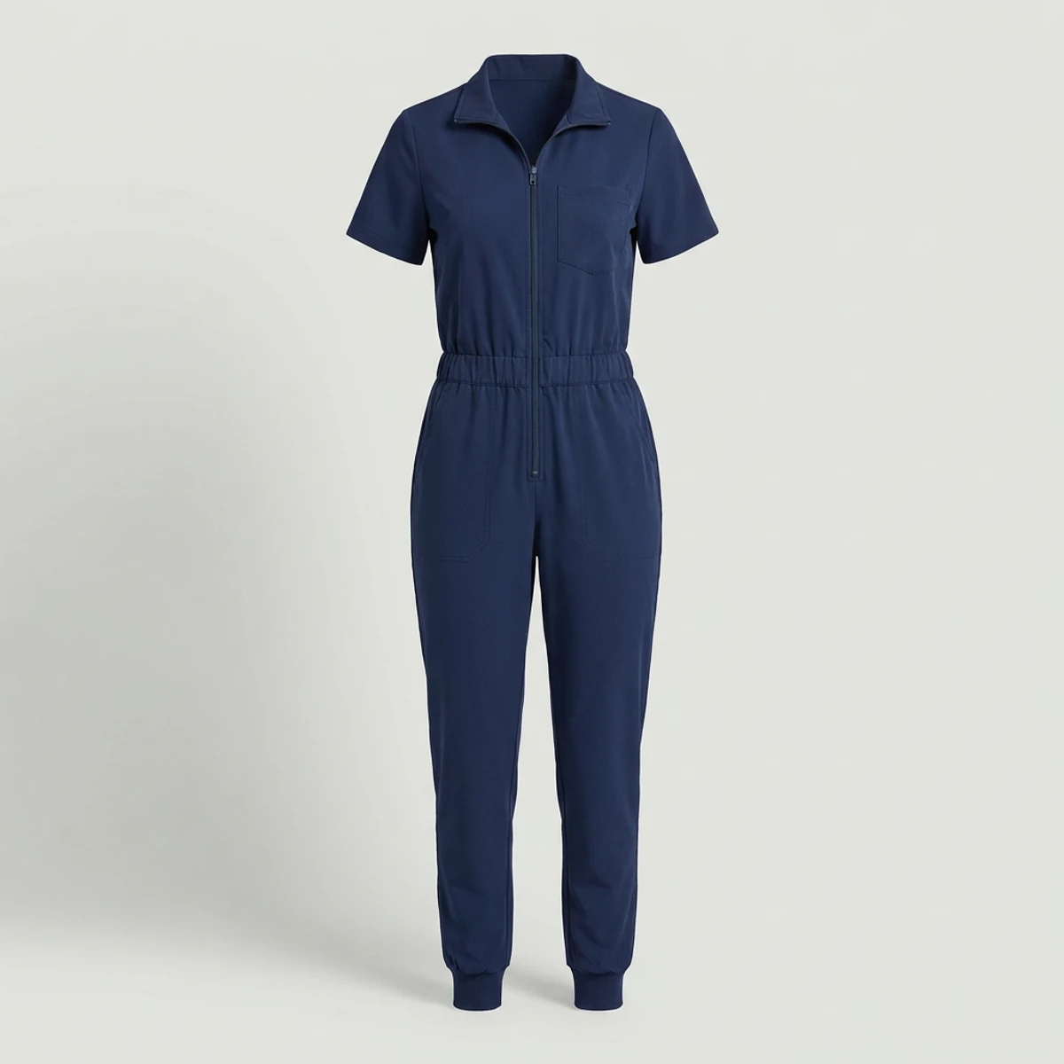 Navy one piece scrub jumpsuit with zip collar and jogger legs